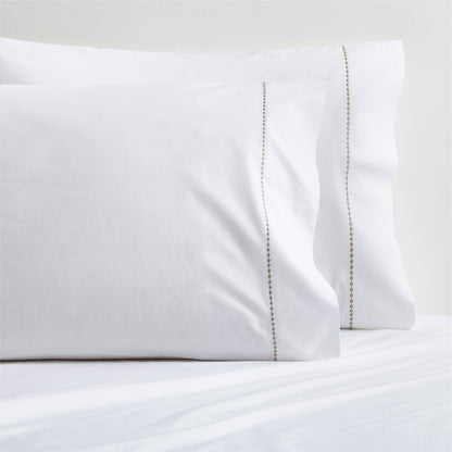 Set of 2 white percale pillowcases with a brown diamond embroidered detail.