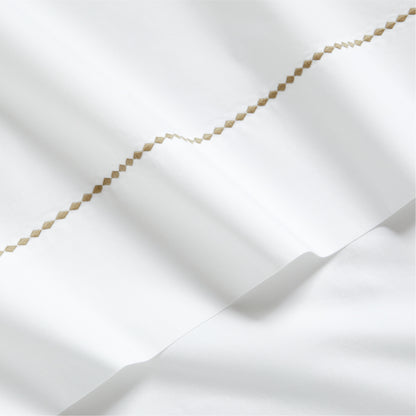 White percale sheet set with brown diamond embroidery detail.