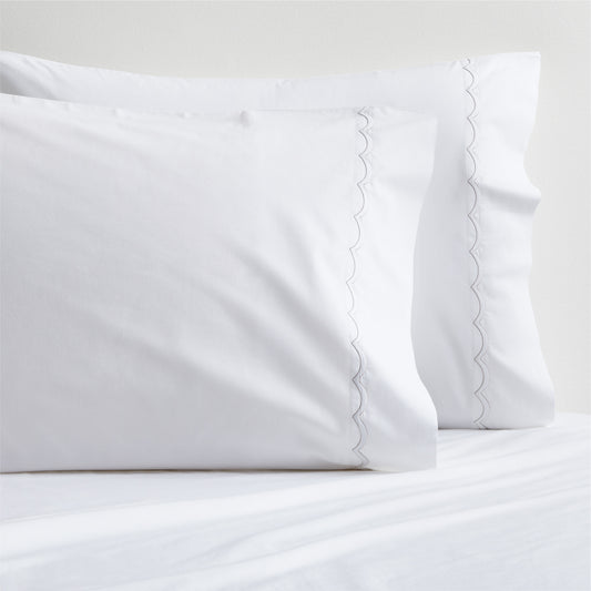White percale pillowcases with subtle brown scallop-stitch trim, set of two.