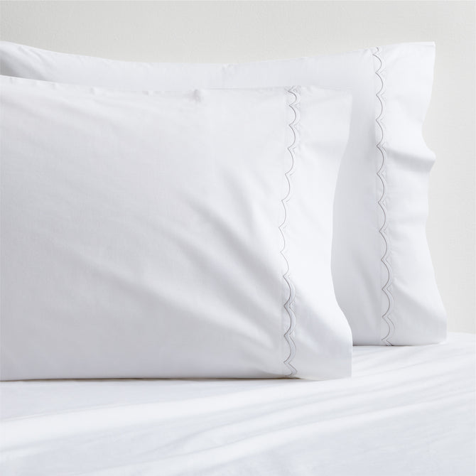 White percale pillowcases with subtle brown scallop-stitch trim, set of two.
