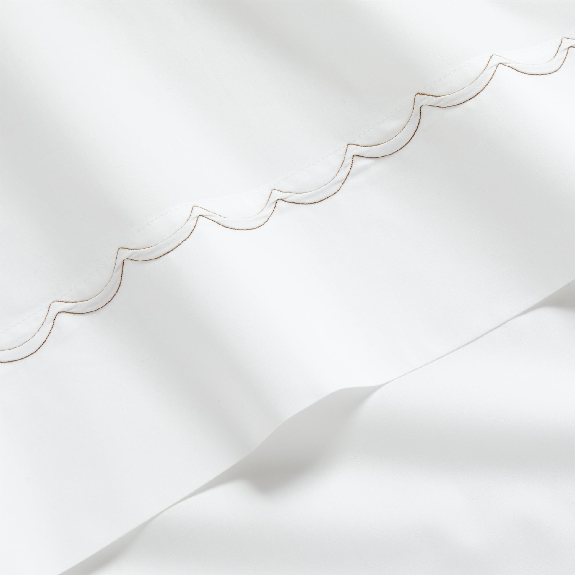 White percale sheet with brown scallop stitch edging.