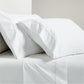 White percale sheet set with brown scallop stitch edging on pillowcases and flat sheet.