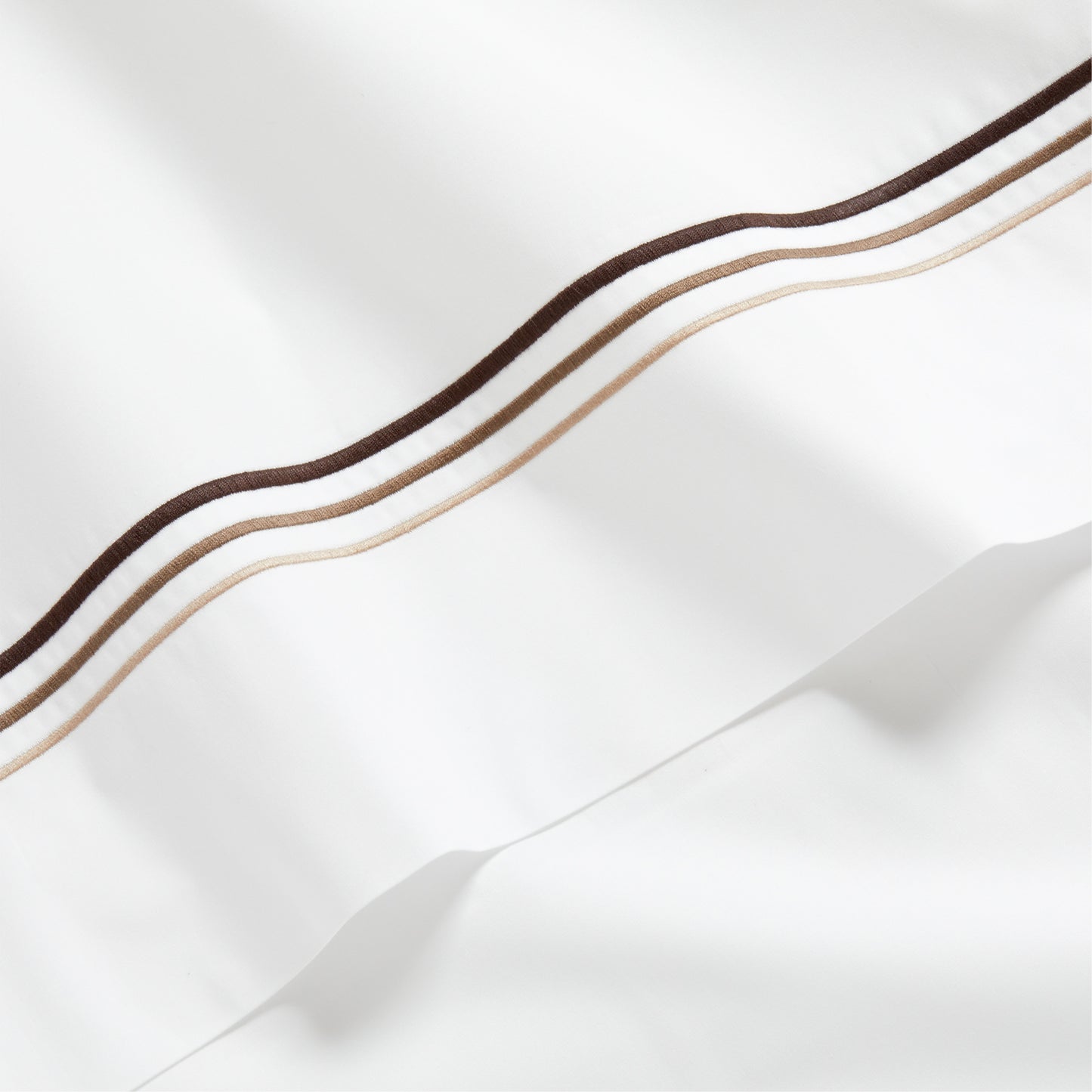 White percale sheet with brown and tan triple stitch edging.