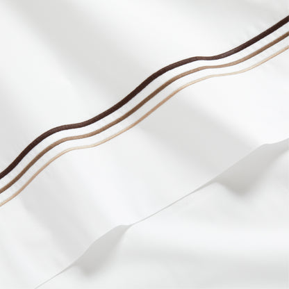 White percale sheet with brown and tan triple stitch edging.