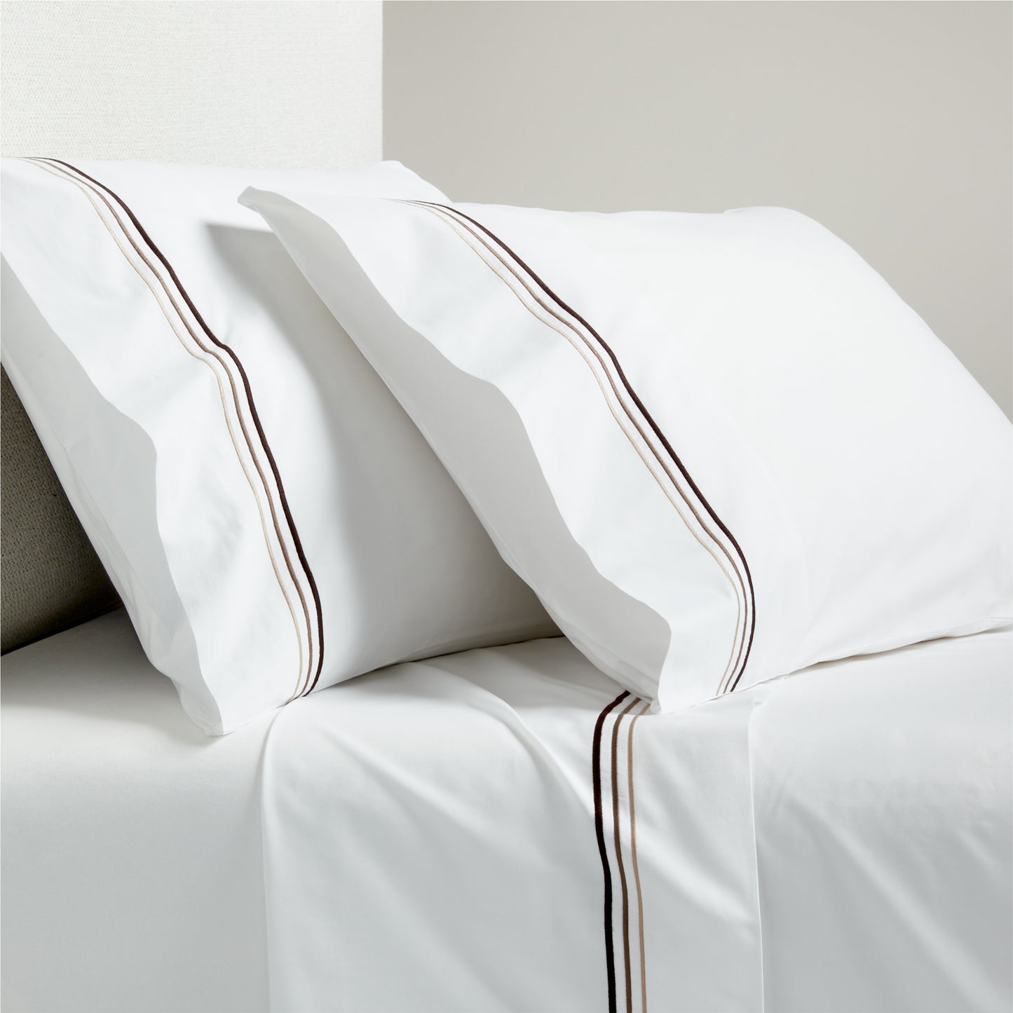 White percale sheet set with brown triple stitch edging on pillowcases and flat sheet.
