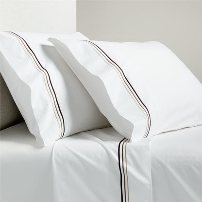 White percale sheet set with brown triple stitch edging on pillowcases and flat sheet.