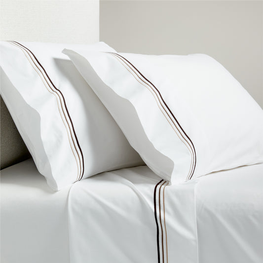 White percale sheet set with brown triple stitch edging on pillowcases and flat sheet.
