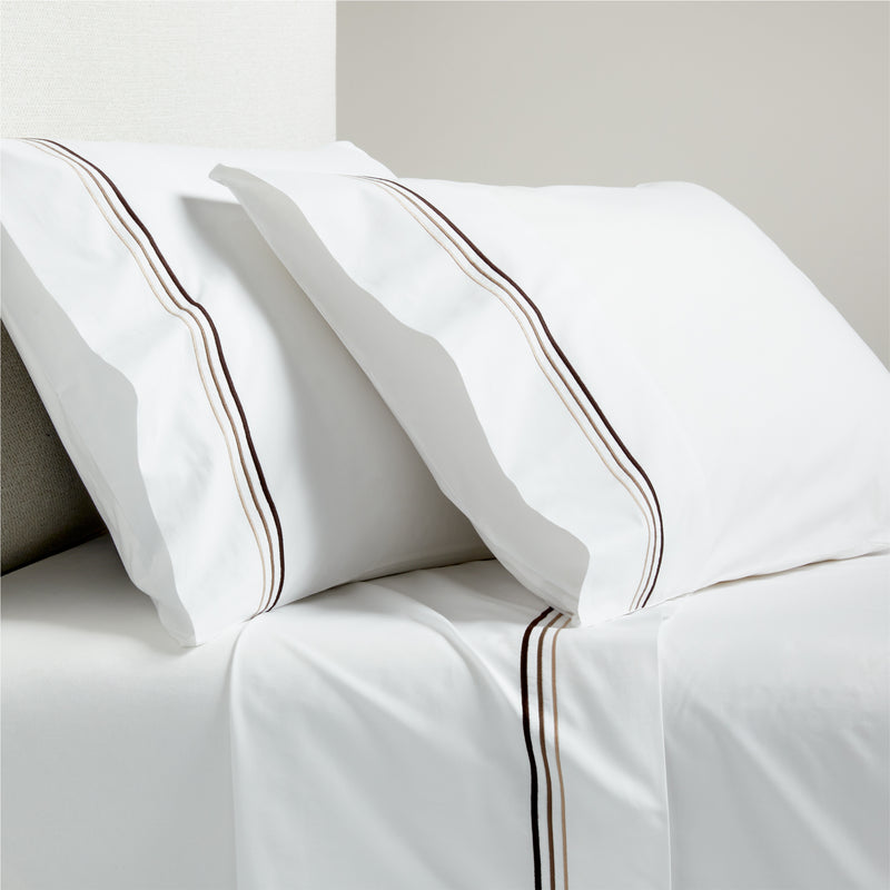 White percale sheet set with brown triple stitch edging on pillowcases and flat sheet.