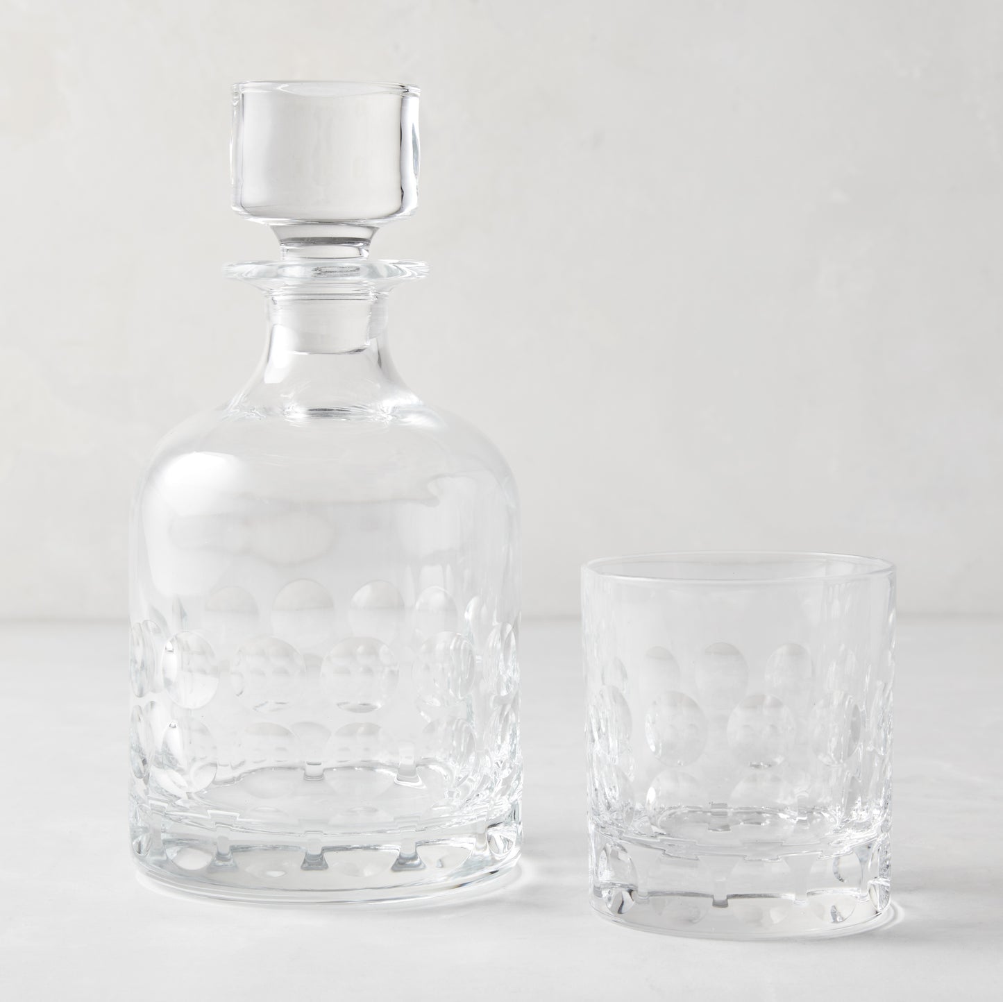 Clear Bubble Eco-Crystal Old Fashioned glass and matching decanter with textured bubble pattern.