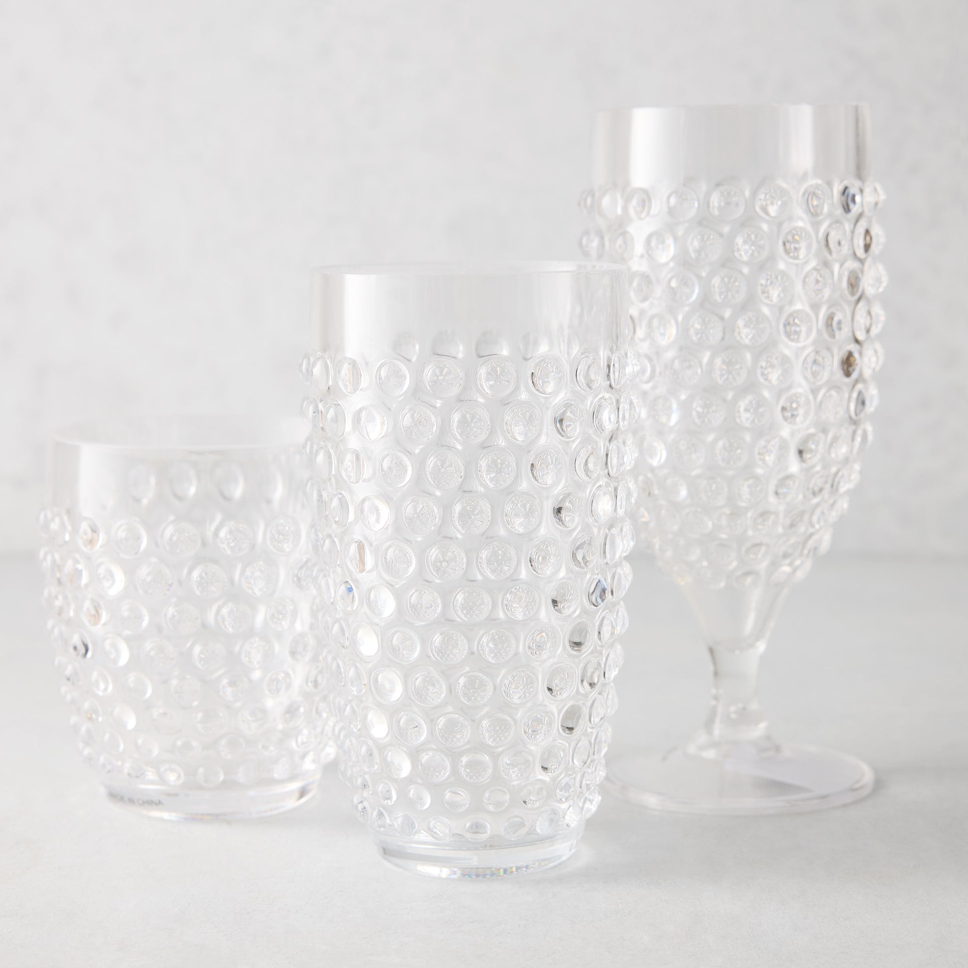 Clear acrylic bubble highball glass, tumbler, and wine glass set.