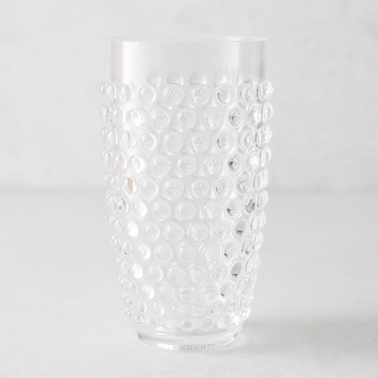 Clear bubble acrylic highball glass, 19oz, with textured dot pattern.
