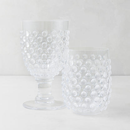 Clear acrylic bubble wine glass and tumbler with textured hobnail design.