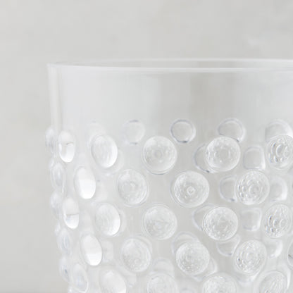 Clear acrylic wine glass with a textured bubble design.