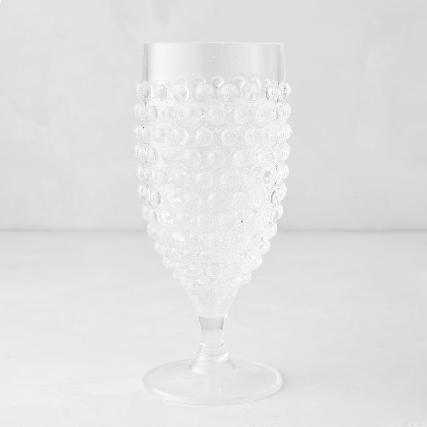 Clear acrylic wine glass with a textured bubble design, 14.6oz, 7.5"H.