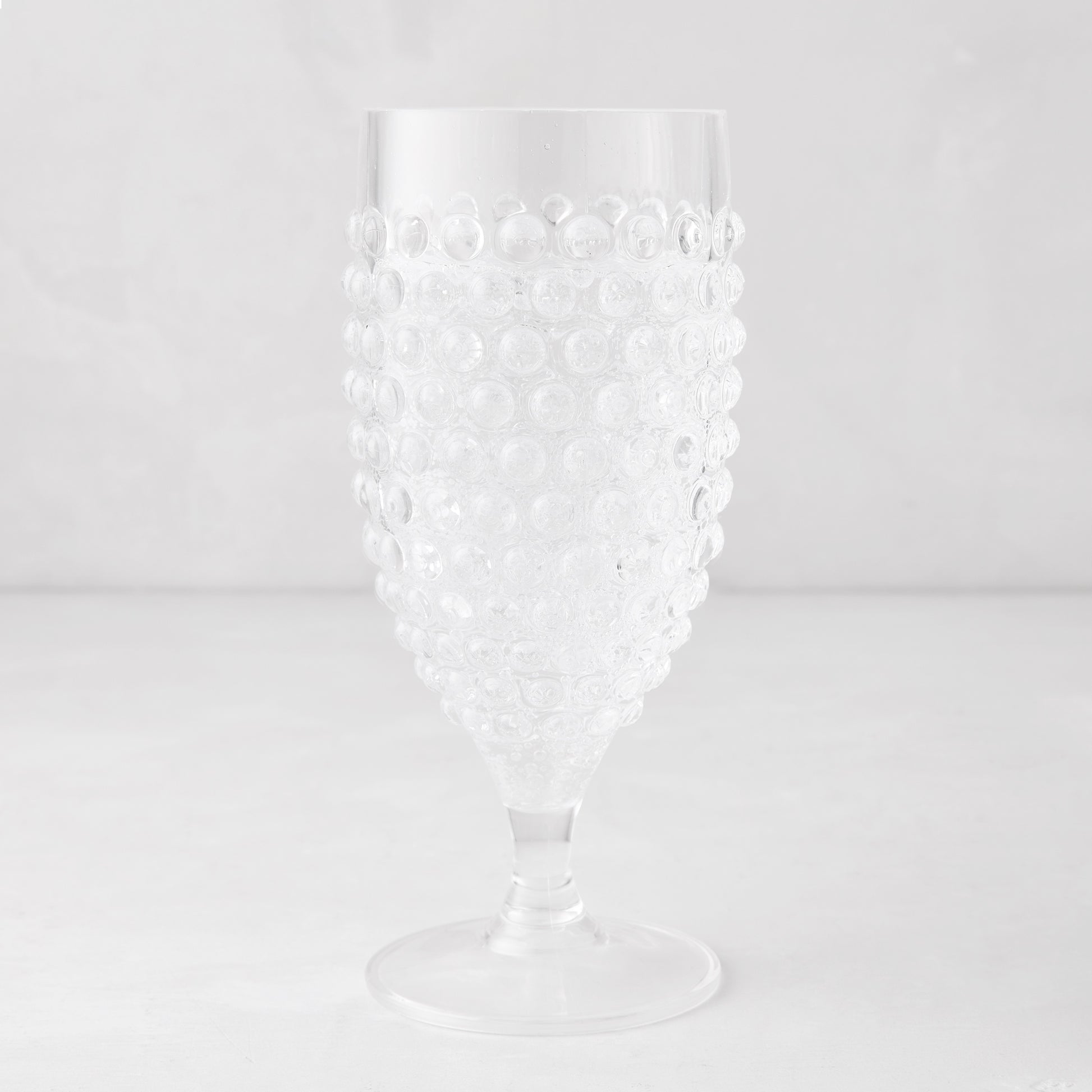 Clear acrylic wine glass with a textured bubble design, 14.6oz, 7.5"H.