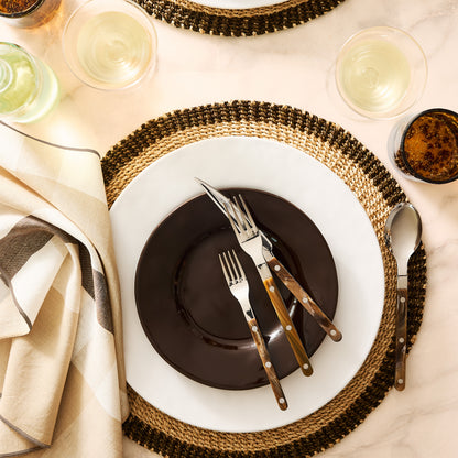 Buffalo Bistro 5-piece flatware set with stainless steel and brown acrylic handles on a table setting.