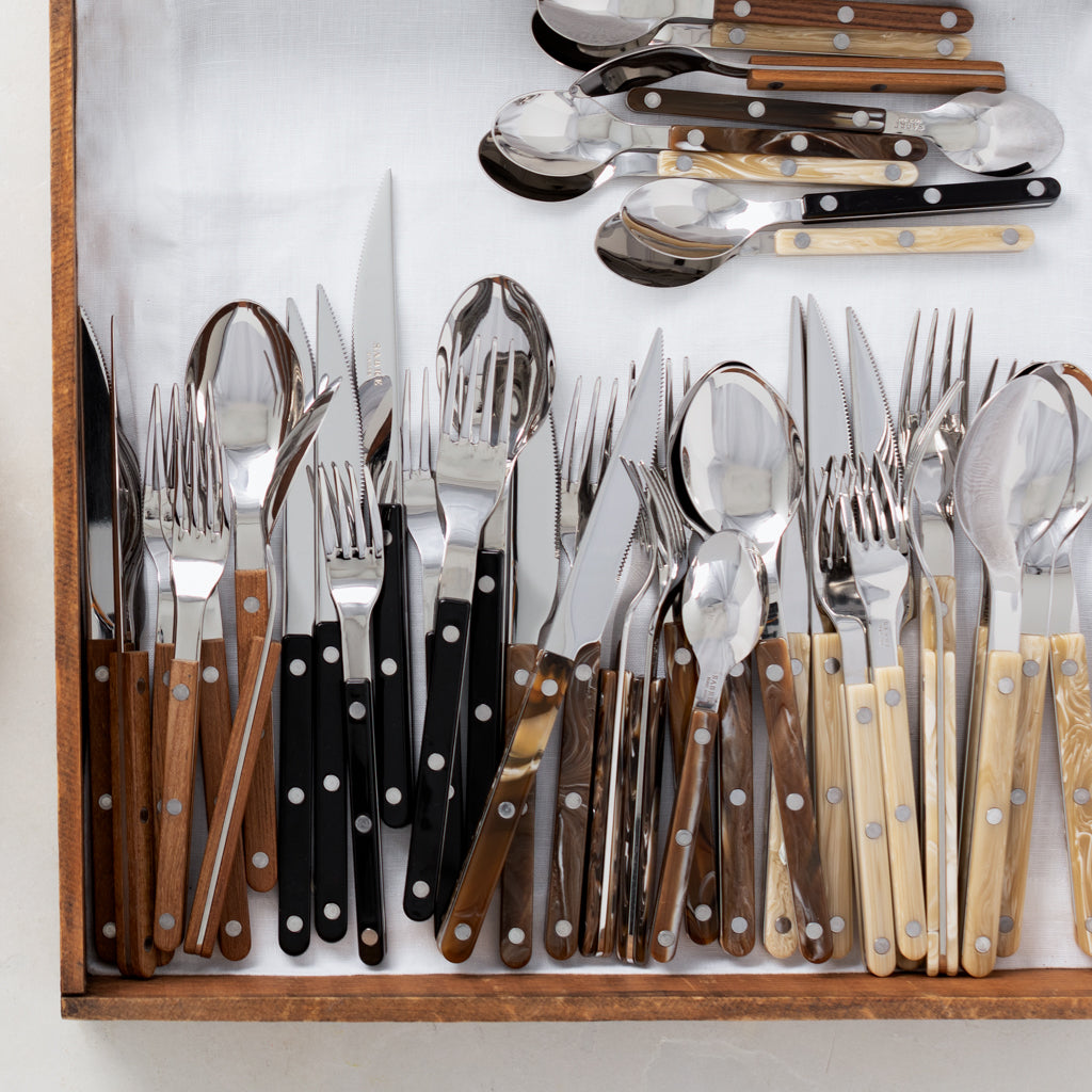 Buffalo Bistro 5-piece flatware sets with stainless steel and acrylic handles in wood, black, and ivory.