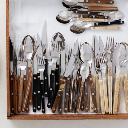 Buffalo Bistro 5-piece flatware sets with stainless steel and acrylic handles in wood, black, and ivory.
