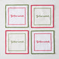 Set of four square white linen coasters with red and green embroidered borders and But First Cocktails text.