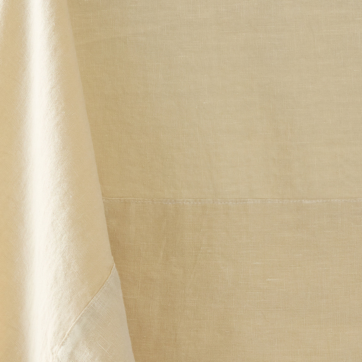 Buttermilk hand-dyed 100% linen tablecloth with a 5-inch border and mitered corner detail.