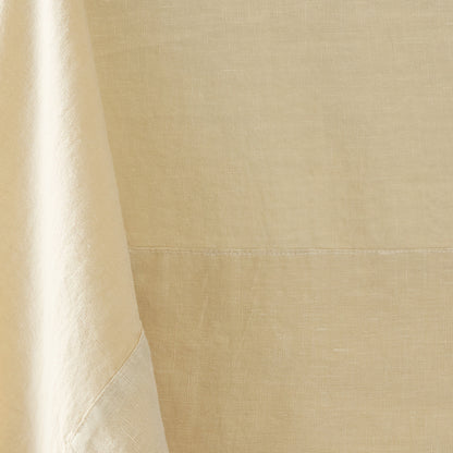 Buttermilk hand-dyed 100% linen tablecloth with a 5-inch border and mitered corner detail.