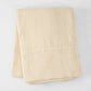 Folded Buttermilk HG Signature Hand-Dyed Linen Tablecloth, 70" x 126", soft khaki color.