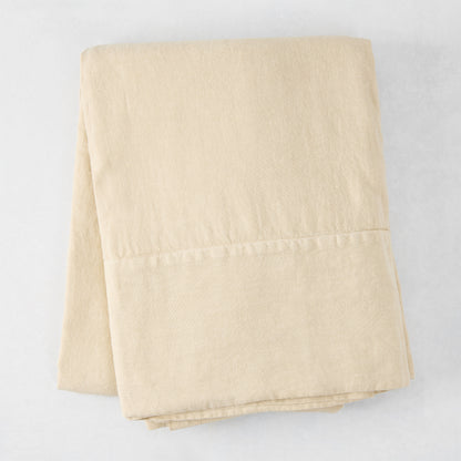 Folded Buttermilk HG Signature Hand-Dyed Linen Tablecloth, 70" x 126", soft khaki color.