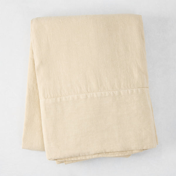 Folded Buttermilk HG Signature Hand-Dyed Linen Tablecloth, 70" x 126", soft khaki color.
