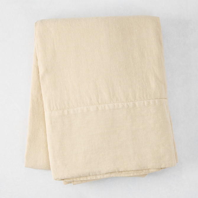 Folded Buttermilk HG Signature Hand-Dyed Linen Tablecloth, 70" x 126", soft khaki color.