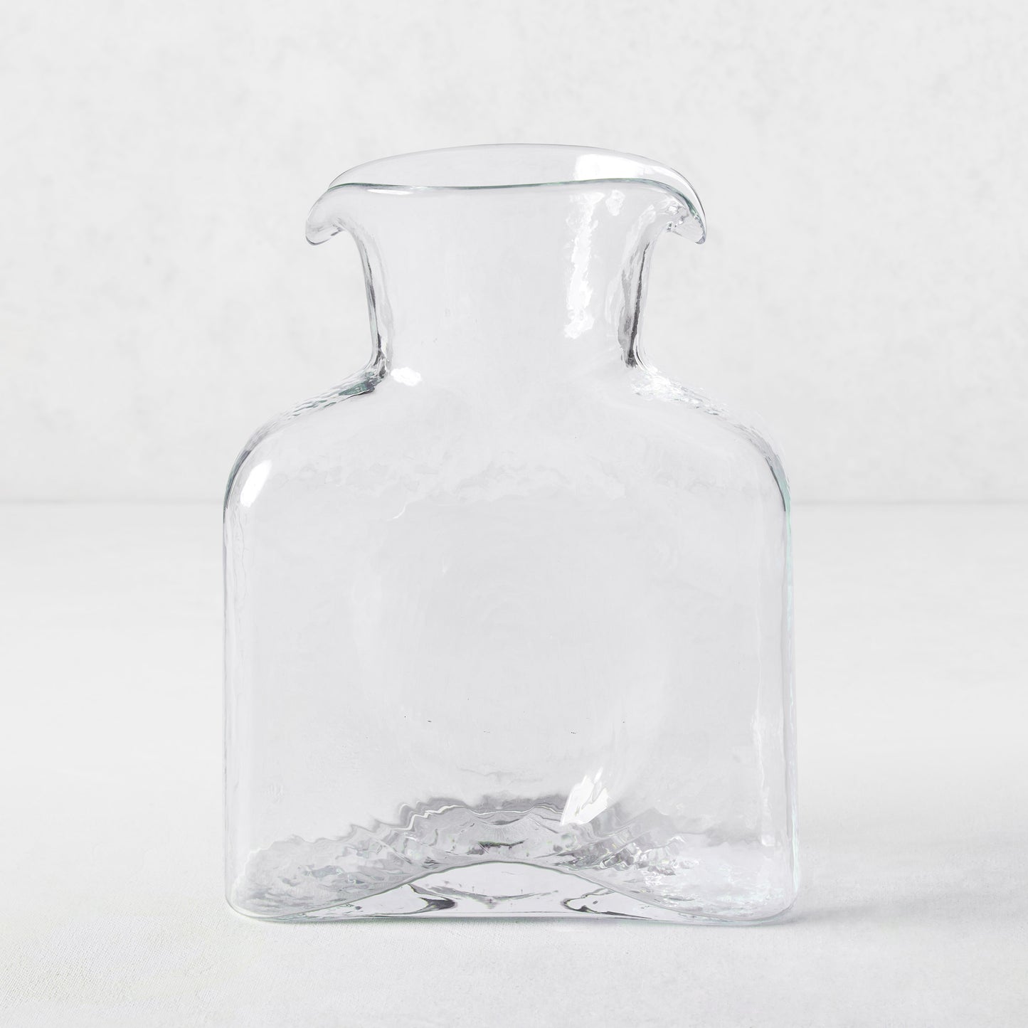 Cabell Square Glass Pitcher, clear hand-blown glass, 8"H, with dual spouts and textured finish.