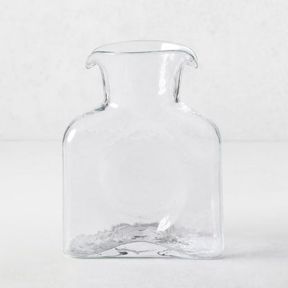 Cabell Square Glass Pitcher, clear hand-blown glass, 8"H, with dual spouts and textured finish.