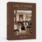 The front and spine of the book 'Call It Home: The Details That Matter' by Amber Lewis, featuring a warm brown cover with a central photograph of a cozy living room.