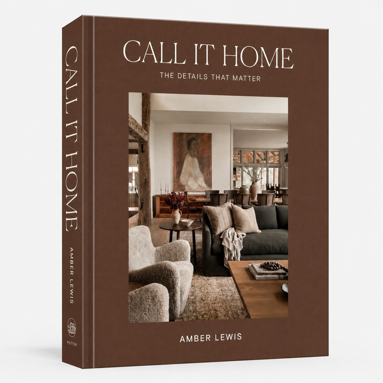 The front and spine of the book 'Call It Home: The Details That Matter' by Amber Lewis, featuring a warm brown cover with a central photograph of a cozy living room.