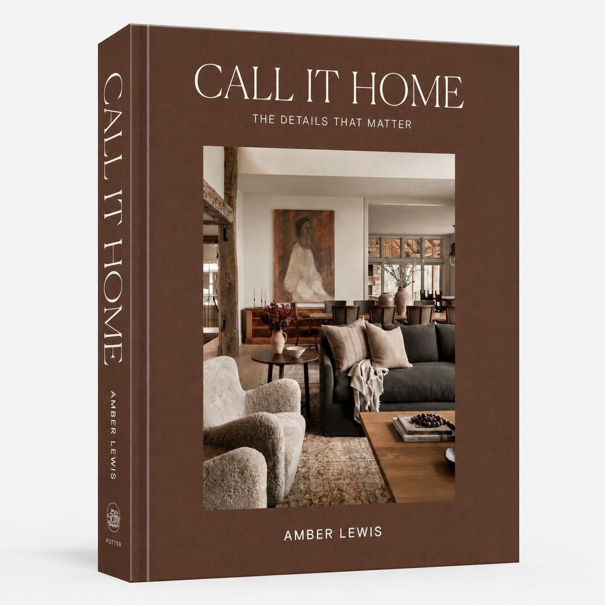 The front and spine of the book 'Call It Home: The Details That Matter' by Amber Lewis, featuring a warm brown cover with a central photograph of a cozy living room.