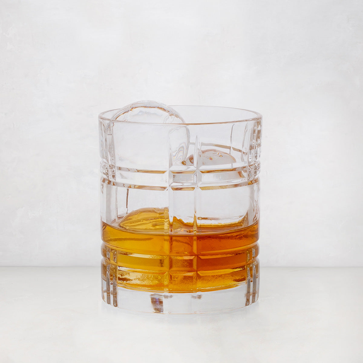 Camden Eco-Crystal Double Old-Fashioned Glass, 11oz, with whiskey and ice, featuring a grid pattern.