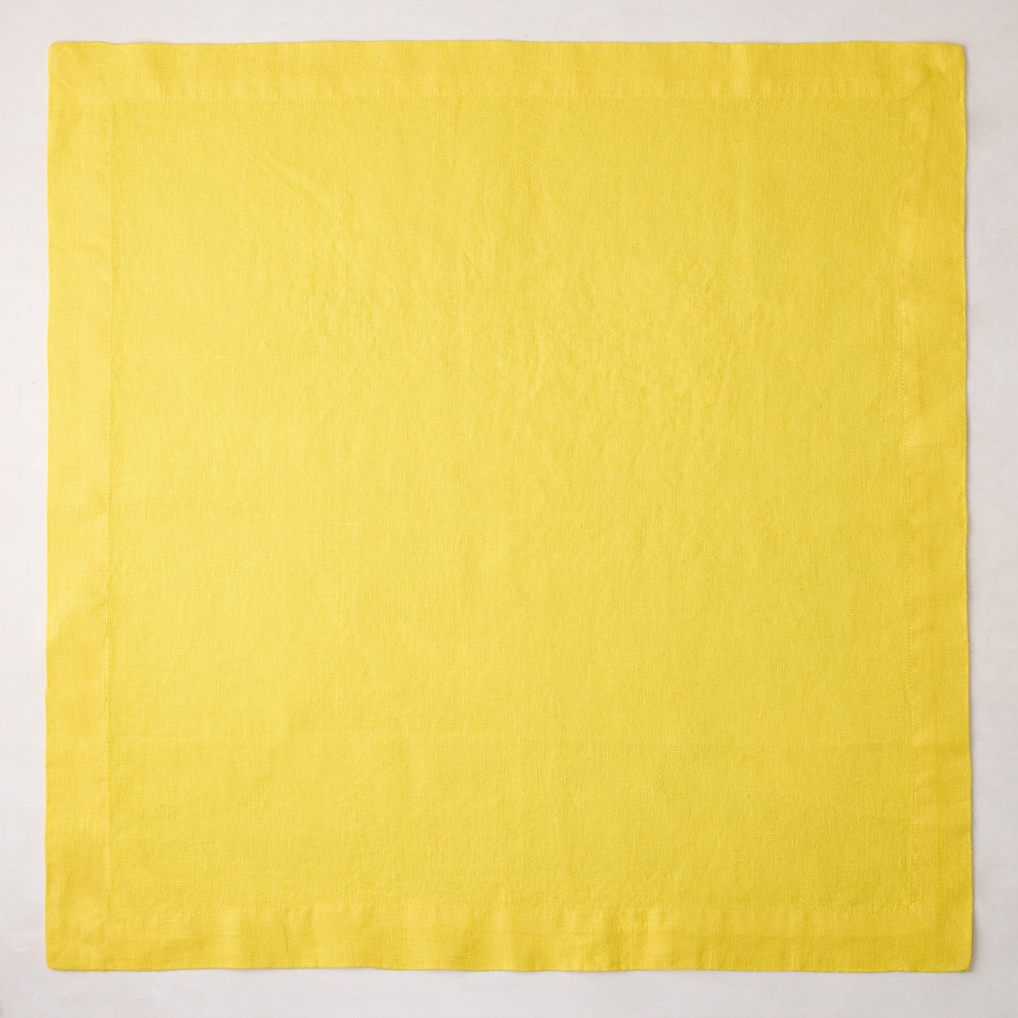 Canary HG Signature hand-dyed 22-inch square linen napkin, bright buttery yellow with mitered corners.