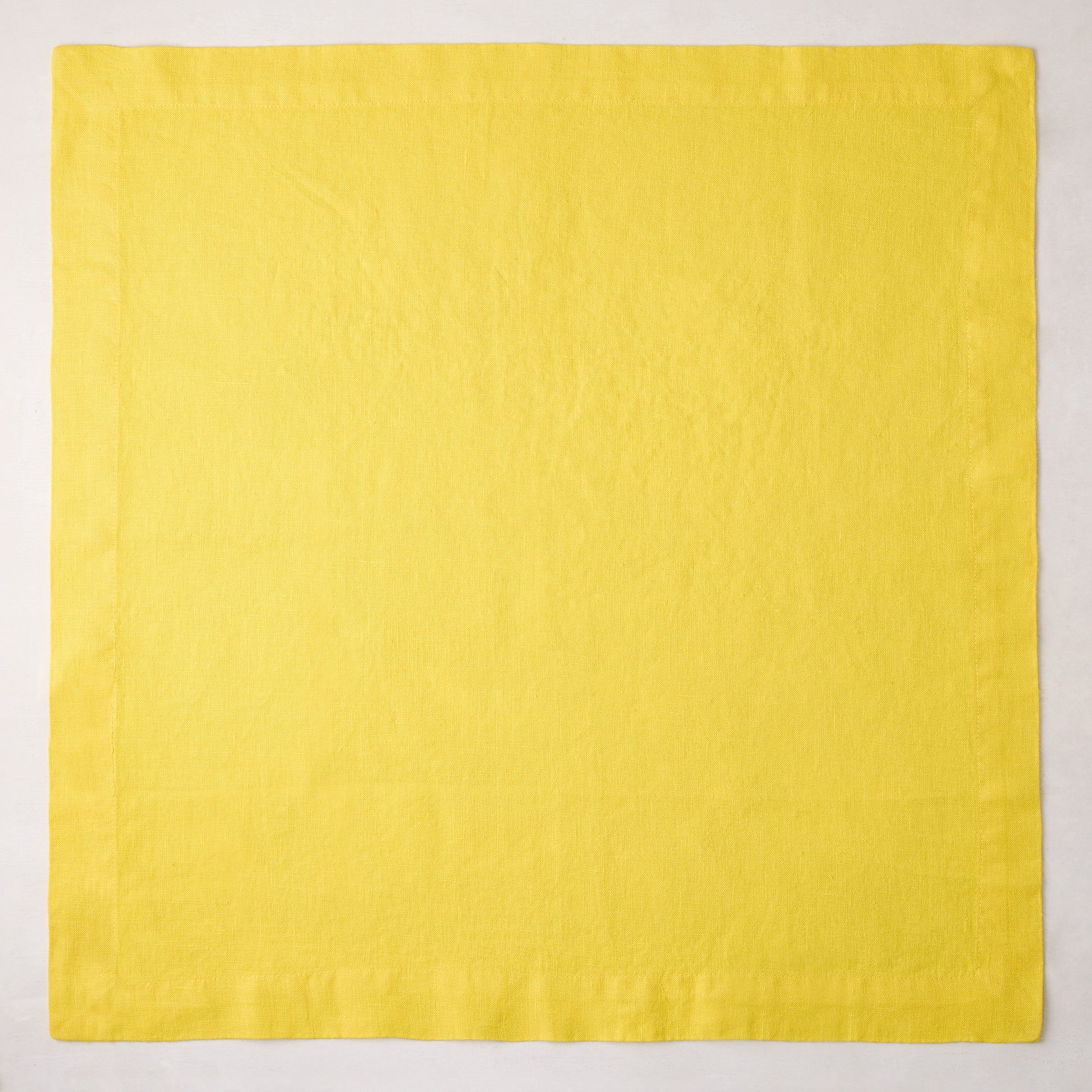 Canary HG Signature hand-dyed 22-inch square linen napkin, bright buttery yellow with mitered corners.