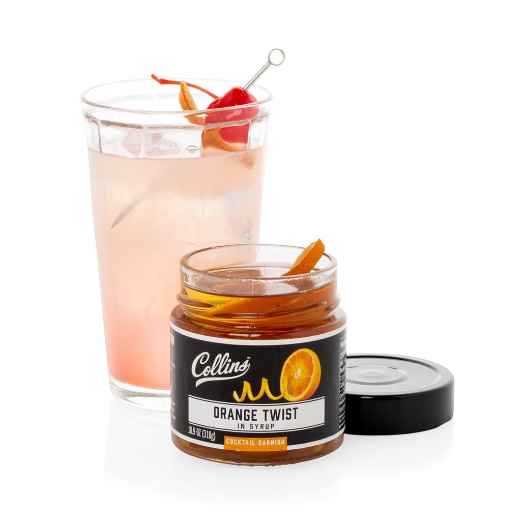 Collins Orange Twist in Syrup jar with an orange peel garnish, next to a pink cocktail with a cherry.