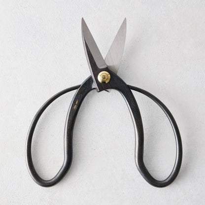 Carbon steel Higurashi garden scissors with dark, uniquely curved handles and a brass pivot.