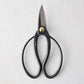 Carbon steel garden shears with dark, curved handles and a brass pivot.