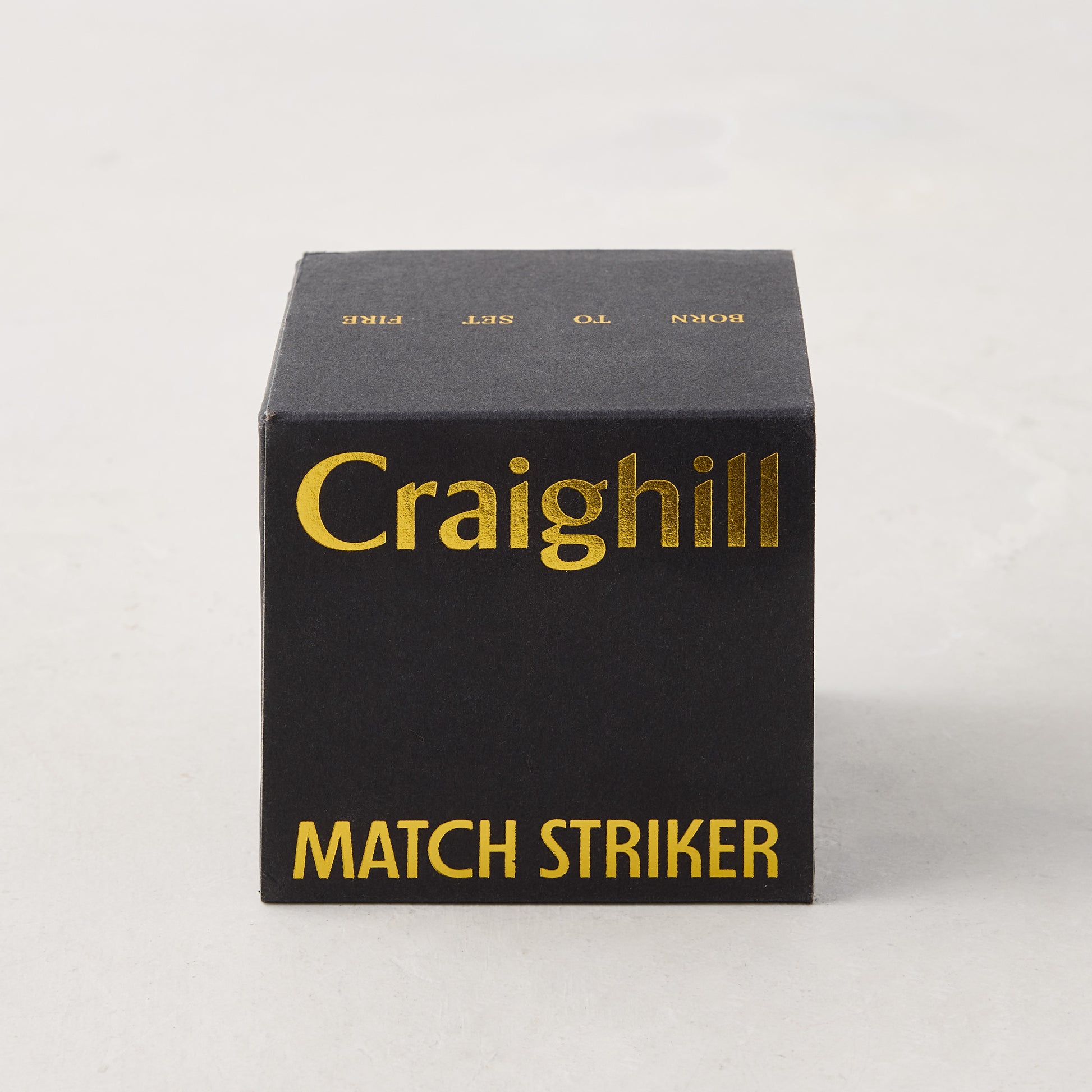 Craighill black match striker box with gold text.