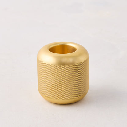 Brass match striker, 2x2x2, with a deep knurling pattern on the exterior surface.
