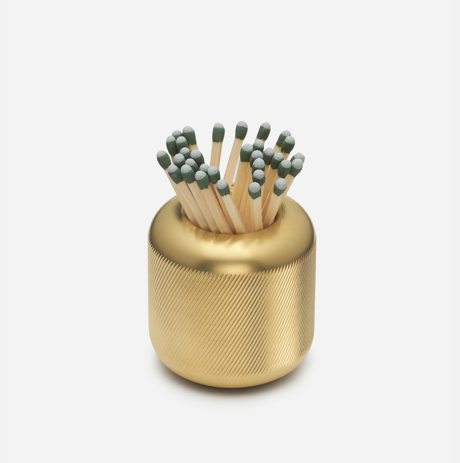 Solid brass match striker with deep knurling, holding matches with green tips.