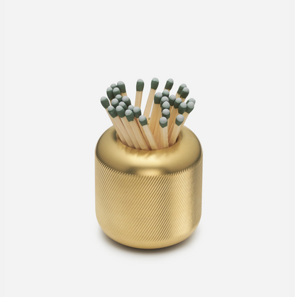 Solid brass match striker with deep knurling, holding matches with green tips.