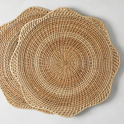 Two round Cebu Scalloped Hapao Placemats, 16.5" diameter, made of honey-brown rattan with a woven pattern.