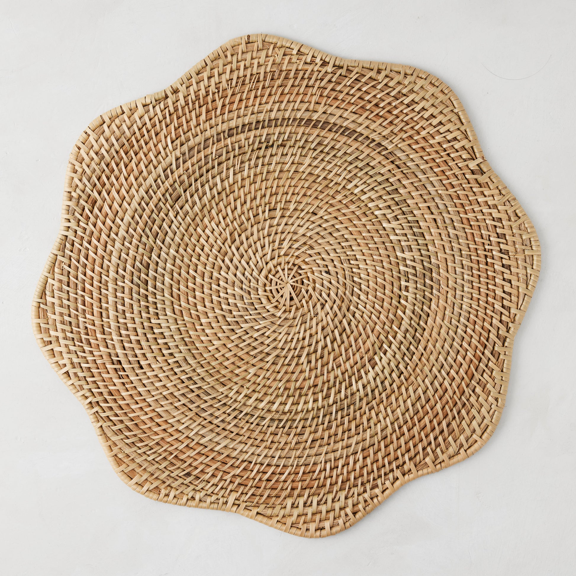 Cebu Scalloped Hapao Placemat, 16" round, natural honey-brown rattan with traditional weave.
