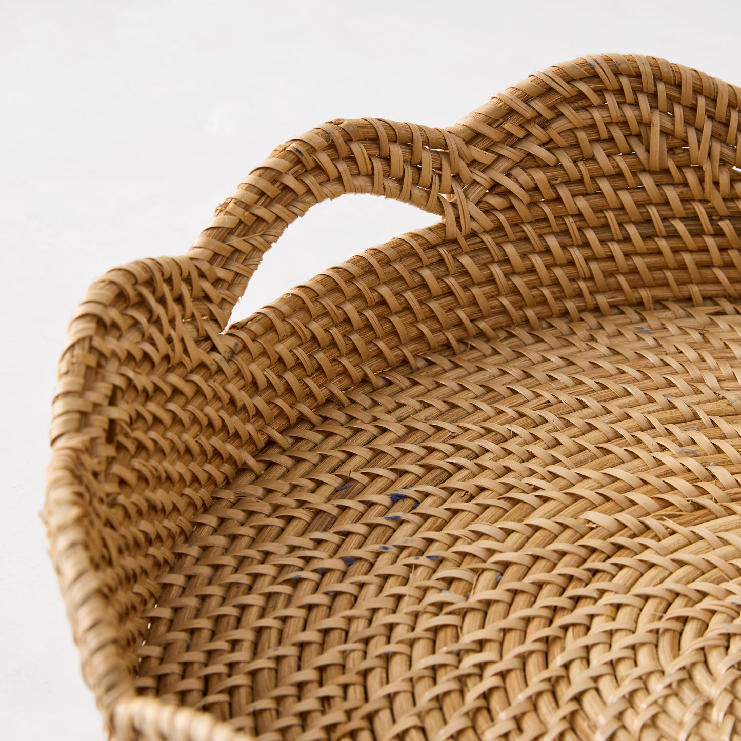 Handcrafted honey-brown rattan Cebu scalloped tray with hapao weave, curved edges, and handles.