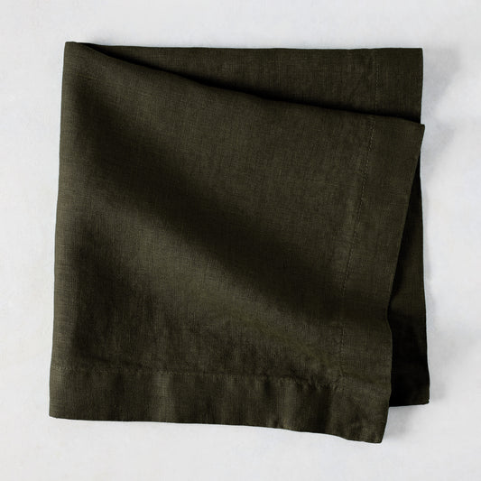 Cedar HG Signature Hand-Dyed Linen Napkin, dark mossy green, folded square, 22-inch.