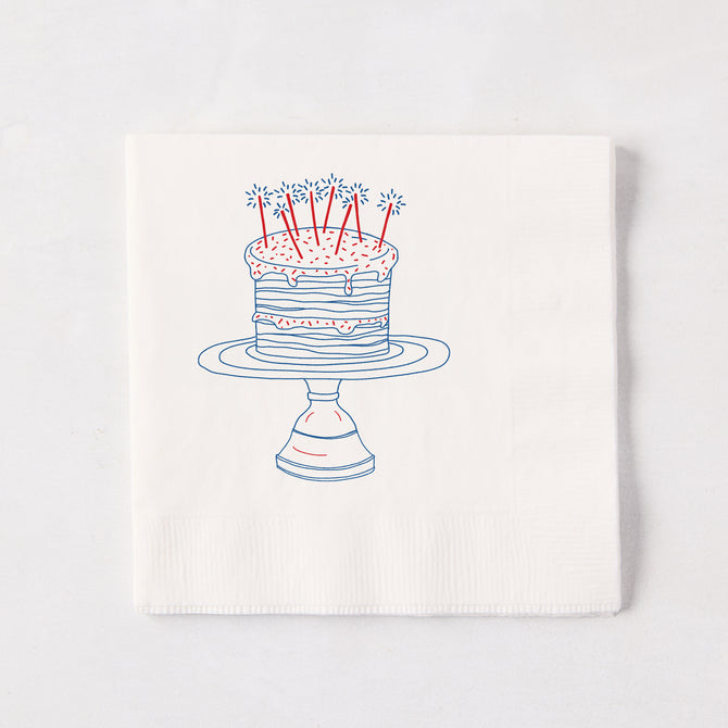 White 3-ply paper cocktail napkin with a blue and red "Celebration Cake" design, 5.5" square.