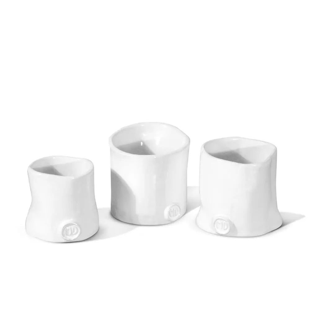 Three Montes Doggett handmade ceramic appetizer bowls in creamy white glaze, varying sizes.